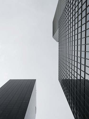 office building low angle photography of glass high rise building grey